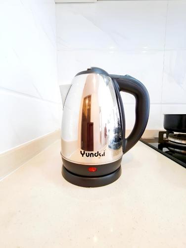 a tea kettle sitting on top of a kitchen counter at Apt SKY house 2br cozy & family in Cisauk 1