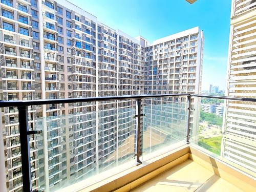a balcony with a view of a large building at Apt SKY house 2br cozy & family in Cisauk 1