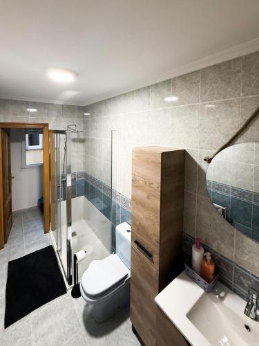 a bathroom with a toilet and a tub and a sink at San Marcos in Ribadeo