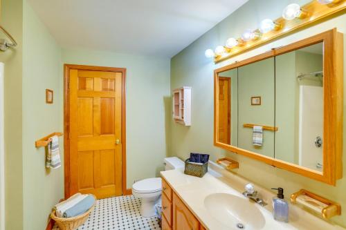 a bathroom with a sink and a toilet and a mirror at Game Room, Hot Tub! Year-Round Dover Retreat in West Dover