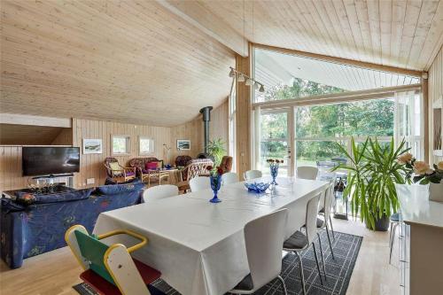 a large dining room with a white table and chairs at 13319-Hojby-Petersvej-4 in Højby