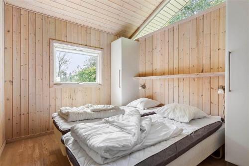 a bedroom with two beds in it with a window at 13319-Hojby-Petersvej-4 in Højby