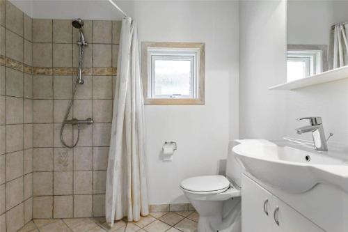 a bathroom with a shower and a toilet and a sink at 13319-Hojby-Petersvej-4 in Højby