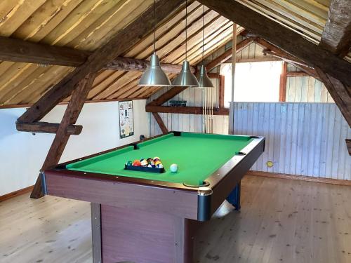 a green pool table in a room with a ceiling at 4 person holiday home in UDDEVALLA in Uddevalla