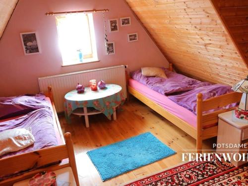 a bedroom with two beds and a table in it at Apartment in the Dutch Quarter in Potsdam
