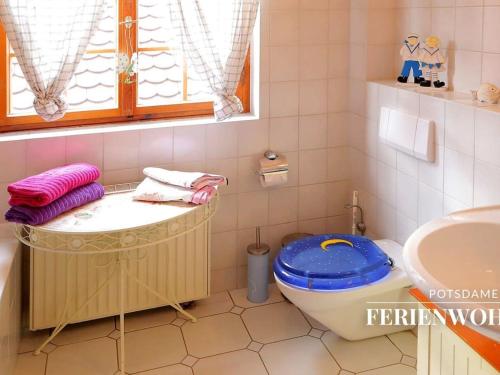 a bathroom with a tub and a toilet and a sink at Apartment in the Dutch Quarter in Potsdam