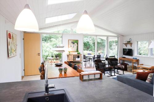 a living room and dining room with large windows at 13373-Asnaes-Radyrvej-24 in Asnæs