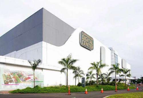 a building with a street sign in front of it at SATU Hotel by Taslim Gading Serpong in Tangerang