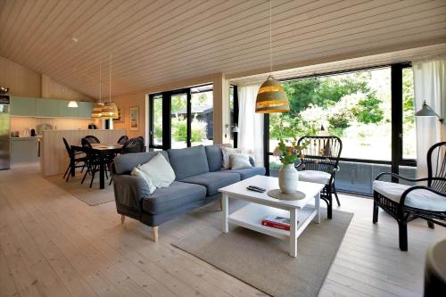 a living room with a couch and a table at 10064-Rorvig-Skansehagevej-12 in Rørvig