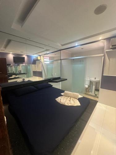 a room with a bed with a glass wall at Pousada Doce Paixão in Belém