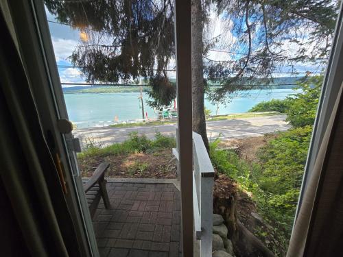 a door leading into a room with a view of the ocean at Lake View Motel in Cooperstown