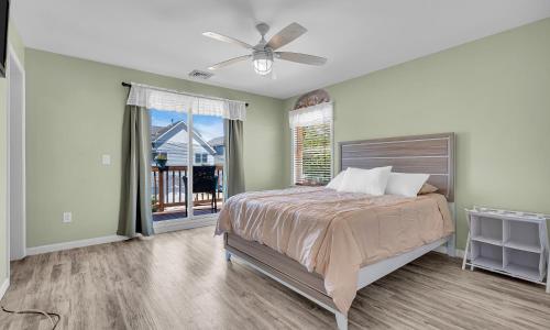 a bedroom with a bed and a ceiling fan at Best Game Room, Kayaks, Steps To The Ocean in Seaside Heights
