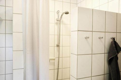 a shower with a shower curtain in a bathroom at 11862-Nykobing-Sj-Hojgardsvej-4 in Klint