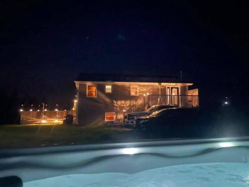 a house at night with a car parked in front of it at Harbours View in Portuguese Cove