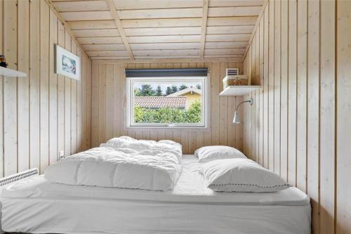 a large bed in a room with a window at 13329-Asnaes-Leifavej-Vestre-11 in Asnæs