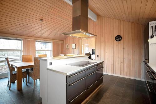 a kitchen with a stove and a table in it at 11806-Nykobing-Sj-Klintegarden-1 in Klint