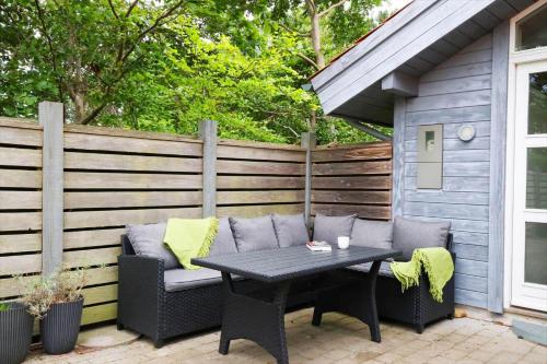 a patio with a table and a bench and a fence at 11806-Nykobing-Sj-Klintegarden-1 in Klint