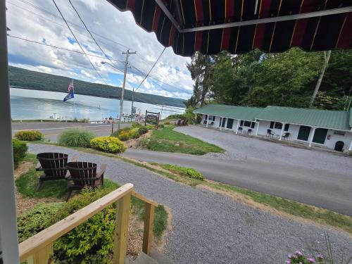 a view of a street with a building and a lake at Lake View Motel in Cooperstown