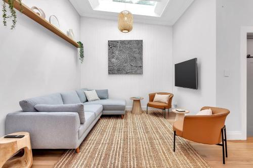 a living room with a couch and a tv at Casa Santorini - Entertainer's Paradise in the Hills in Bridgewater