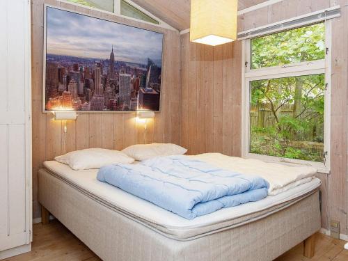 a bed in a room with a window at 8 person holiday home in Rønde-By Traum in Rønde