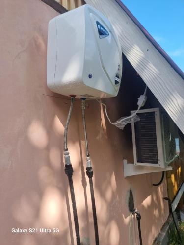 a air conditioner on the side of a building at Puri Ma'u Beach & Bungalows in Boba
