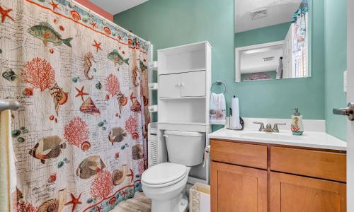 a bathroom with a toilet and a shower curtain at Best Game Room, Kayaks, Steps To The Ocean in Seaside Heights