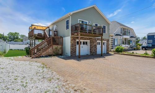 a house with a brick driveway in front of it at Best Game Room, Kayaks, Steps To The Ocean in Seaside Heights