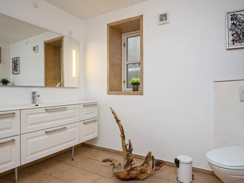 a bathroom with a sink and a toilet and a window at Panoramic Retreat by Water - By Traum Ferienwohnungen in Børkop