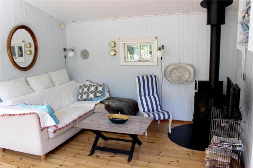 a living room with a white couch and a table at 12255-Sjaellands-Odde-Klokkelyngvej-5 in Tjørneholm