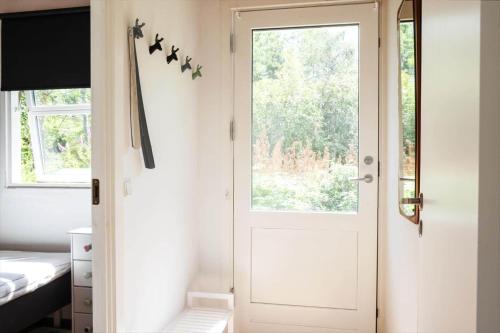 a white door in a room with a window at 11815-Nykobing-Sj-Birkevaenget-21 in Klint