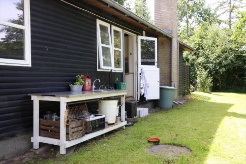 a house with a table with a sink in the yard at 11815-Nykobing-Sj-Birkevaenget-21 in Klint
