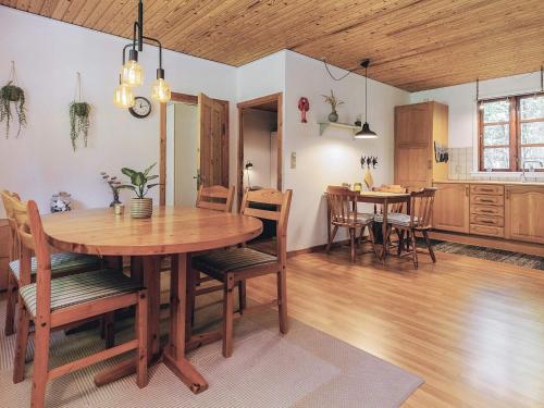 a kitchen and dining room with a wooden table and chairs at 4 person holiday home in Læsø in Læsø
