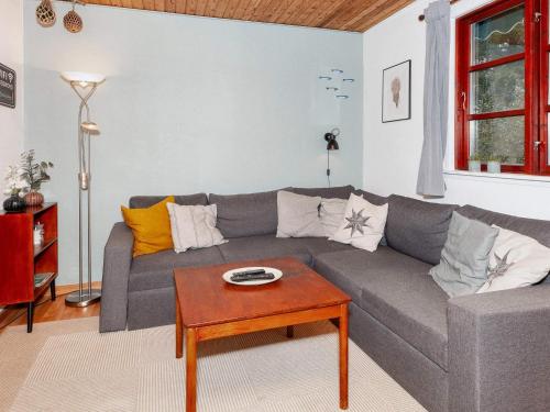 a living room with a gray couch and a table at 4 person holiday home in Læsø in Læsø