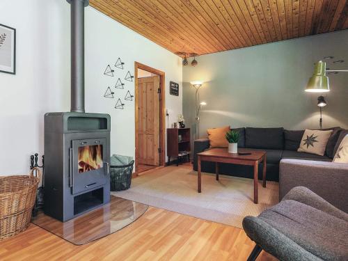 a living room with a fireplace and a couch at 4 person holiday home in Læsø in Læsø