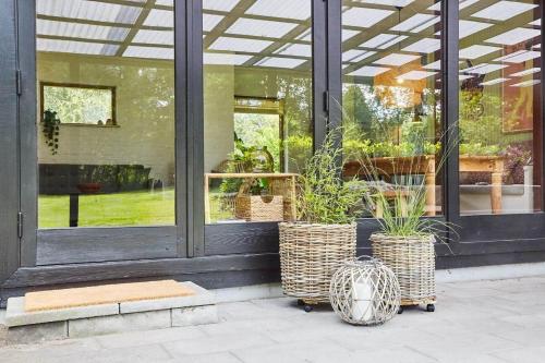 a store with two potted plants in front of a window at 10000-1-Rorvig-Birkealle-2-A in Rørvig