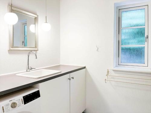 a white kitchen with a sink and a window at 14235-Grevinge-Askebjerggardsvej-20 in Grevinge
