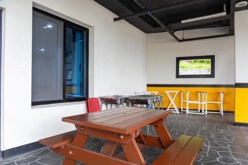 a room with a wooden table and chairs in it at Gangneung the One and the Classic Pension in Gangneung