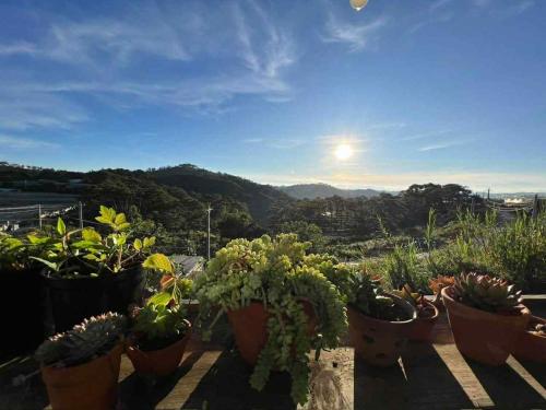 a bunch of potted plants sitting on a balcony at Nhà Ngoại Ô in Ấp Man Ling