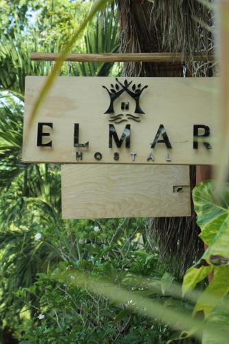 a sign for the entrance to the rainforest at Elmar Hostel in Bacalar
