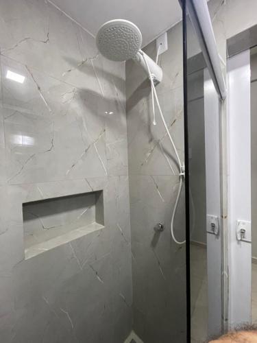 a shower with a shower head in a bathroom at Flat Centro Rio Av Presidente Vargas x Uruguaiana - Vista panorâmica do Cristo & Metrô in Rio de Janeiro