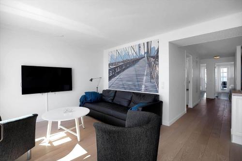 a living room with a couch and a table at 11203-Nykobing-Sj-Havnevej-63-st-th in Nykøbing Sjælland