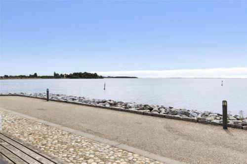 a row of rocks on the side of a body of water at 11203-Nykobing-Sj-Havnevej-63-st-th in Nykøbing Sjælland