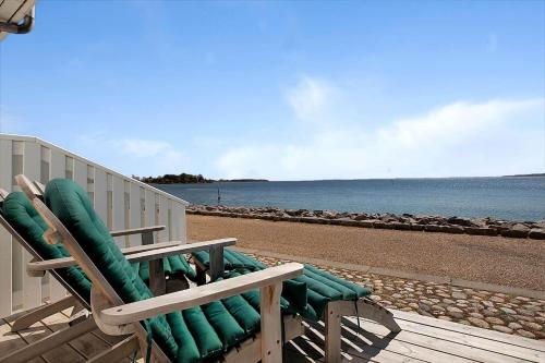 two lawn chairs sitting on a beach next to the water at 11203-Nykobing-Sj-Havnevej-63-st-th in Nykøbing Sjælland