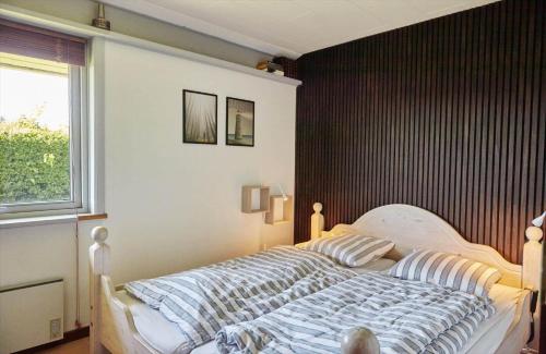 a bedroom with a bed with a black wall at 14249-Grevinge-Strandmosen-4 in Grevinge