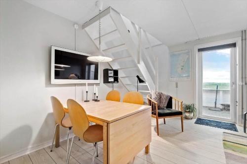 a dining room with a table and chairs at 0366-Romo-Vestergade-153-B-Ap-126 in Sønderby
