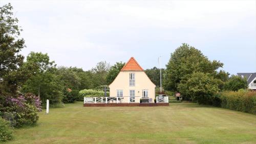 a small white house with an orange roof on a yard at 10098-Rorvig-Fjordvaenget-17 in Rørvig