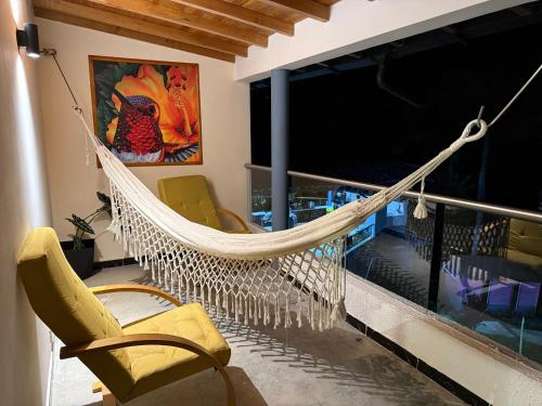 a hammock on the balcony of a house at Hotel Selva Cristal in San Carlos