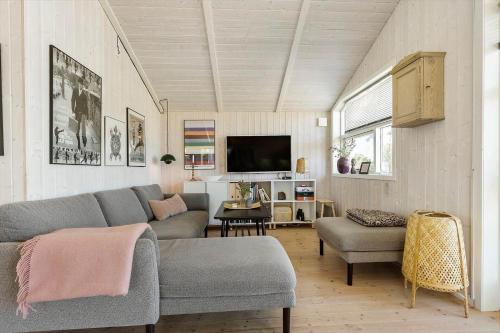 a living room with a couch and a tv at 8014-Knebel-Rastestedet-16 in Knebel