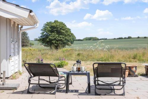 two chairs and a table on a patio at 8014-Knebel-Rastestedet-16 in Knebel