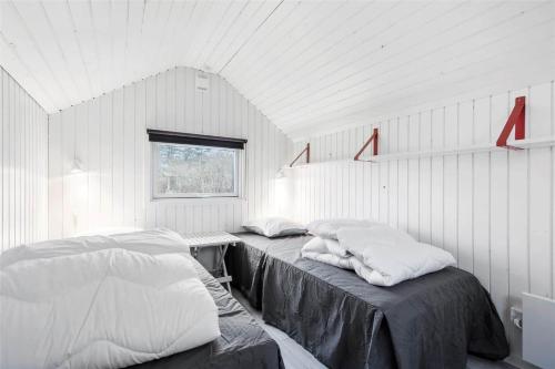a white room with two beds and a window at 13338-Asnaes-Hogevej-22 in Asnæs
